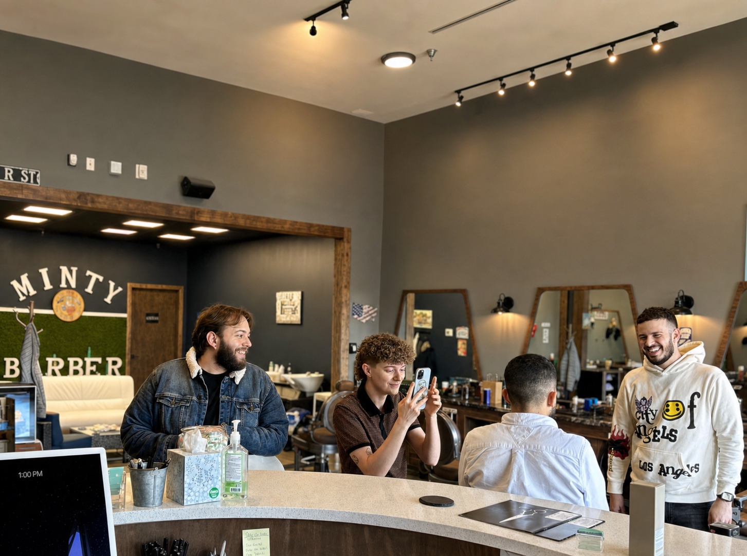 Minty Barber team members sharing a relaxed moment inside the shop